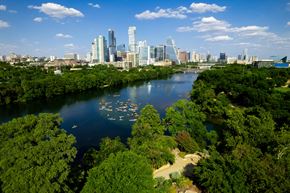 Houston apartment for rent - an aerial view of a river with a city skyline in the background