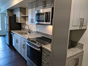 Seattle apartment for rent - Kitchen with Black Appliances at AJ, Washington, 98116