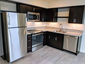 Seattle apartment for rent - a kitchen with stainless steel appliances and granite counter tops