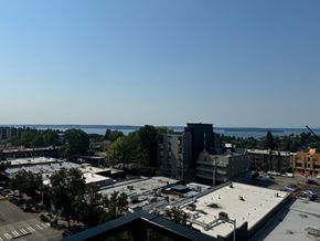 Seattle apartment for rent - an aerial view of a city with a body of water in the background at Junction Central, Seattle Washington