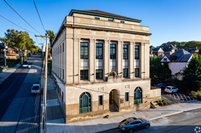 Homestead apartment for rent - A large building with a green door sits on the corner of a street.