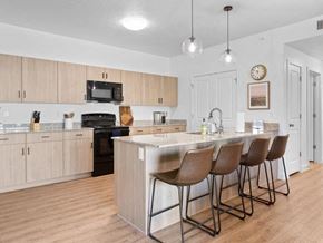 Washington apartment for rent - A kitchen with a bar and chairs.