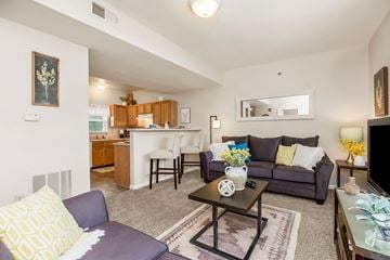 Topeka apartment for rent - A living room with a grey couch and a coffee table.