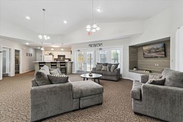 Belleville apartment for rent - A spacious living room with grey couches and a patterned carpet.