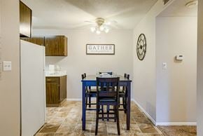 Lincoln apartment for rent - a dining table with blue chairs in a kitchen with a refrigerator