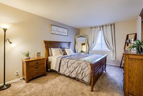 Lincoln apartment for rent - a bedroom with a bed and a dresser and a window