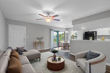 Bradenton apartment for rent - A living room with a grey couch and a brown armchair.