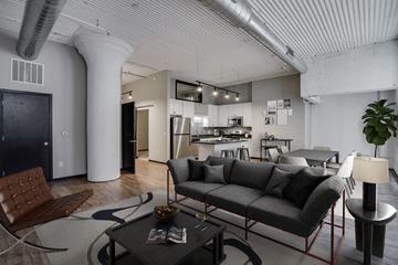 St. Paul apartment for rent - A modern living room with a grey sofa and a coffee table.