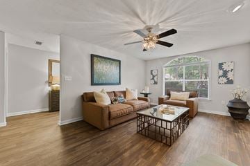 Southaven apartment for rent - A living room with a brown couch and a painting on the wall.