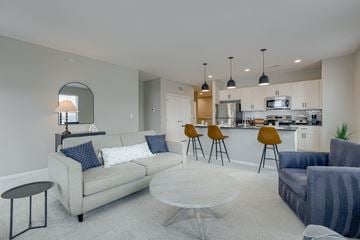 Omaha apartment for rent - a living room and kitchen with a couch and a table