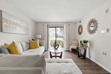Hazelwood apartment for rent - A living room with a grey couch and a painting on the wall.