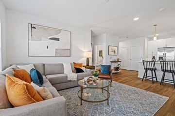 Shakopee apartment for rent - A living room with a grey couch, a coffee table, and a painting on the wall.