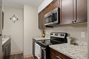 Overland Park apartment for rent - Renovated Kitchen With Espresso Cabinets, Granite Counters & Stainless Steel Appliances