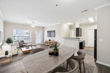 Smyrna apartment for rent - A spacious living room with a large marble table and comfortable seating.