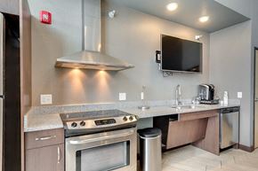 Bismarck apartment for rent - a kitchen with stainless steel appliances and a counter with a stove and a television
