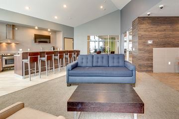 Bismarck apartment for rent - a living room with a blue couch in front of a bar
