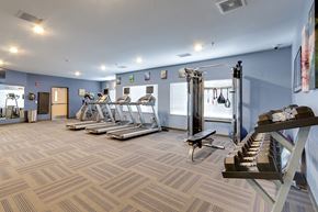 Bismarck apartment for rent - a gym with treadmills and weights and a staircase