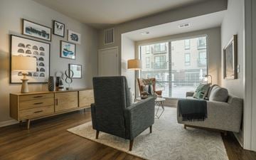Bloomington apartment for rent - a living room with furniture and a large window