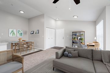 Mulberry apartment for rent - A living room with a grey couch and a dining table.