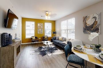 Rogers apartment for rent - a living room with yellow walls and a couch and a table