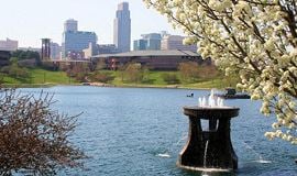 Ankeny apartment for rent - a fountain in a lake with a city in the background