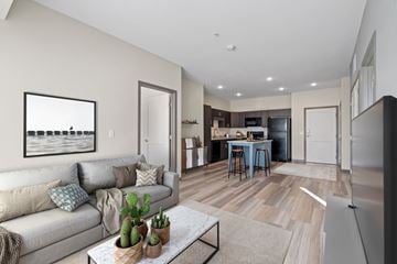 Rogers apartment for rent - A living room with a couch, coffee table, and a painting on the wall.