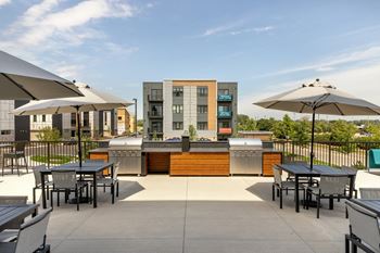 Two outdoor patios with kitchens and firepits