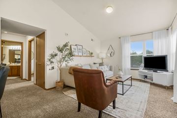 Gardner apartment for rent - A living room with a brown chair and a white couch.