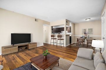 Hoover apartment for rent - A living room with a grey sofa and a wooden coffee table.