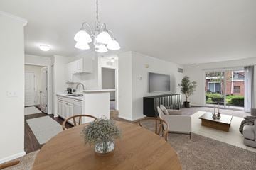 Howell apartment for rent - A modern living room with a wooden table and a television.