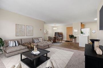 St. Cloud apartment for rent - A living room with a grey couch and a black coffee table.