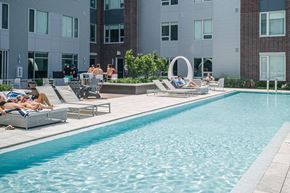 Cleveland apartment for rent - Pool surrounded by residents in lounge chairs