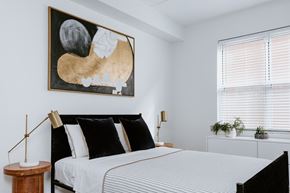 Cleveland apartment for rent - a bedroom with a large bed and a large painting on the wall