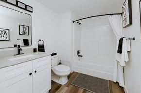 Cleveland apartment for rent - a bathroom with a white toilet next to a bathtub with a shower curtain