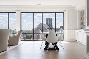 Cleveland apartment for rent - Lounge with modern dining table and chairs, bar and view of city out windows.