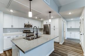Redlands apartment for rent - A modern kitchen with a large island and stainless steel appliances.