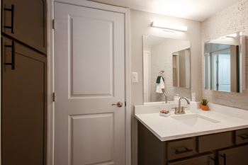 A bathroom with a sink and a mirror
