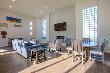 Tempe apartment for rent - A living room with a fireplace and a dining table set up.