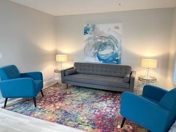 Phoenix apartment for rent - a living room with a couch and two blue chairs