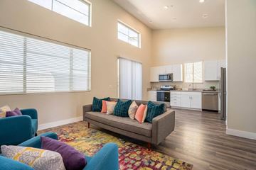 Queen Creek apartment for rent - a living room with a couch and a kitchen in the background