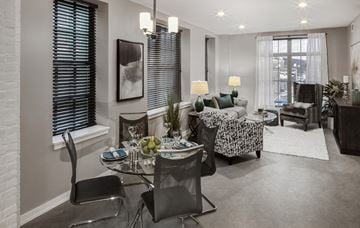 Troy apartment for rent - a living room with a glass table and chairs