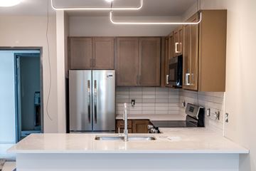 Troy apartment for rent - A modern kitchen with a white countertop and stainless steel appliances.