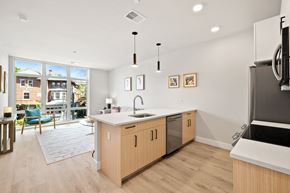 Philadelphia apartment for rent - an open kitchen and living room with a sliding glass door to a patio