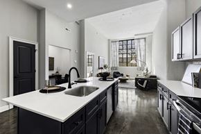 Philadelphia apartment for rent - a kitchen with a large white counter top and a sink