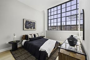 Philadelphia apartment for rent - a bedroom with a bed and a large window