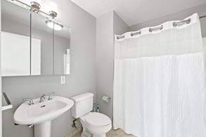 Philadelphia apartment for rent - a bathroom with a white sink and toilet next to a white shower curtain