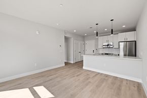 Philadelphia apartment for rent - an open kitchen and living room with a large island and a refrigerator and microwave