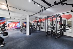 Philadelphia apartment for rent - a gym with weights machines and ads on the wall