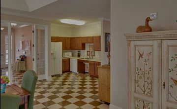 Greenville apartment for rent - A kitchen with a checkered floor and wooden cabinets.