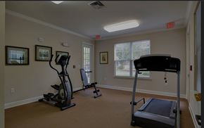 Greenville apartment for rent - A room with a treadmill, a stationary bike, and a weight machine.
